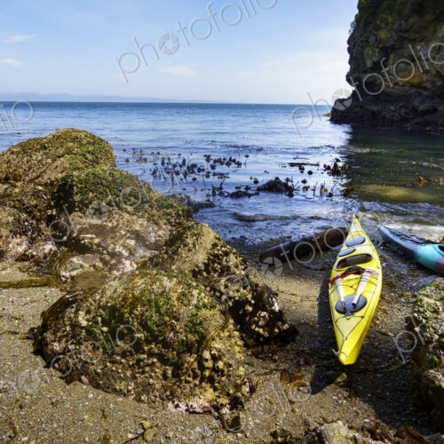 Kayaks on shore of a pocket beach along the Strait of Juan de Fuca, Port Angeles Kayaks on shore of a pocket beach along the Strait of Juan de Fuca, Port Angeles