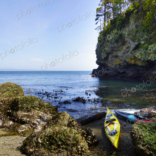 Kayaks on shore of pocket beach along the Strait of Juan de Fuca, Port Angeles Kayaks on shore of pocket beach along the Strait of Juan de Fuca, Port Angeles