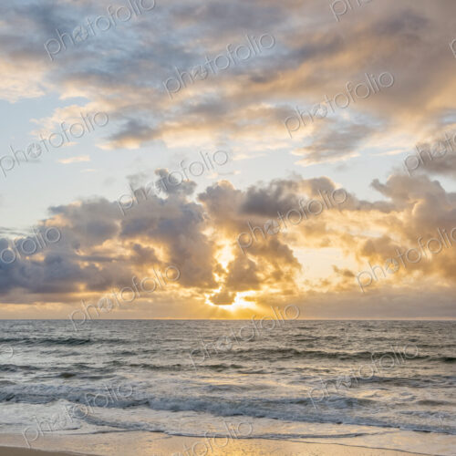 Kealia Beach, Kauai, sunrise view from the beach, clouds lit up by sunlight. Kealia Beach, Kauai, sunrise view from the beach, clouds lit up by sunlight.