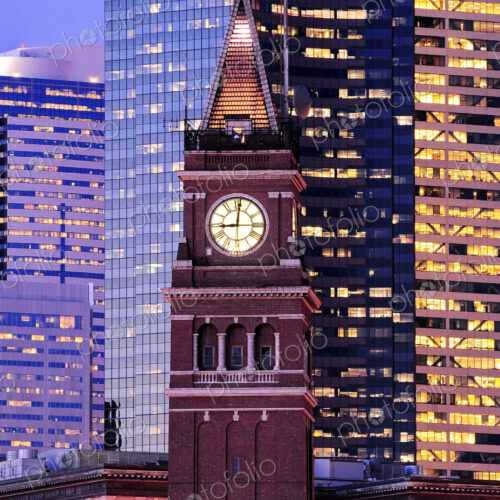 King street station clock, among tall skyscrapers in Seattle at dusk. King street station clock, among tall skyscrapers in Seattle at dusk.