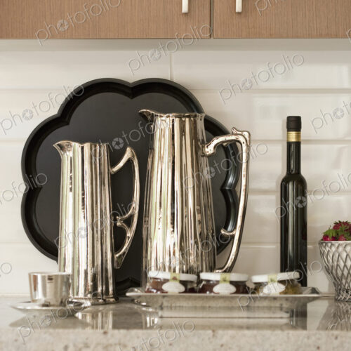 Kitchen Counter, close up of metal jugs, coffee pots.