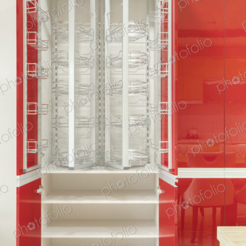 Kitchen cupboard with stainless steel metal racking, microwave oven and a stainless…