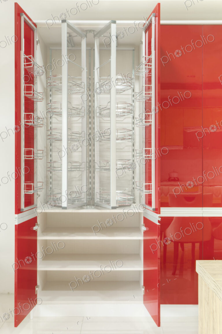 Kitchen cupboard with stainless steel metal racking, microwave oven and a stainless…