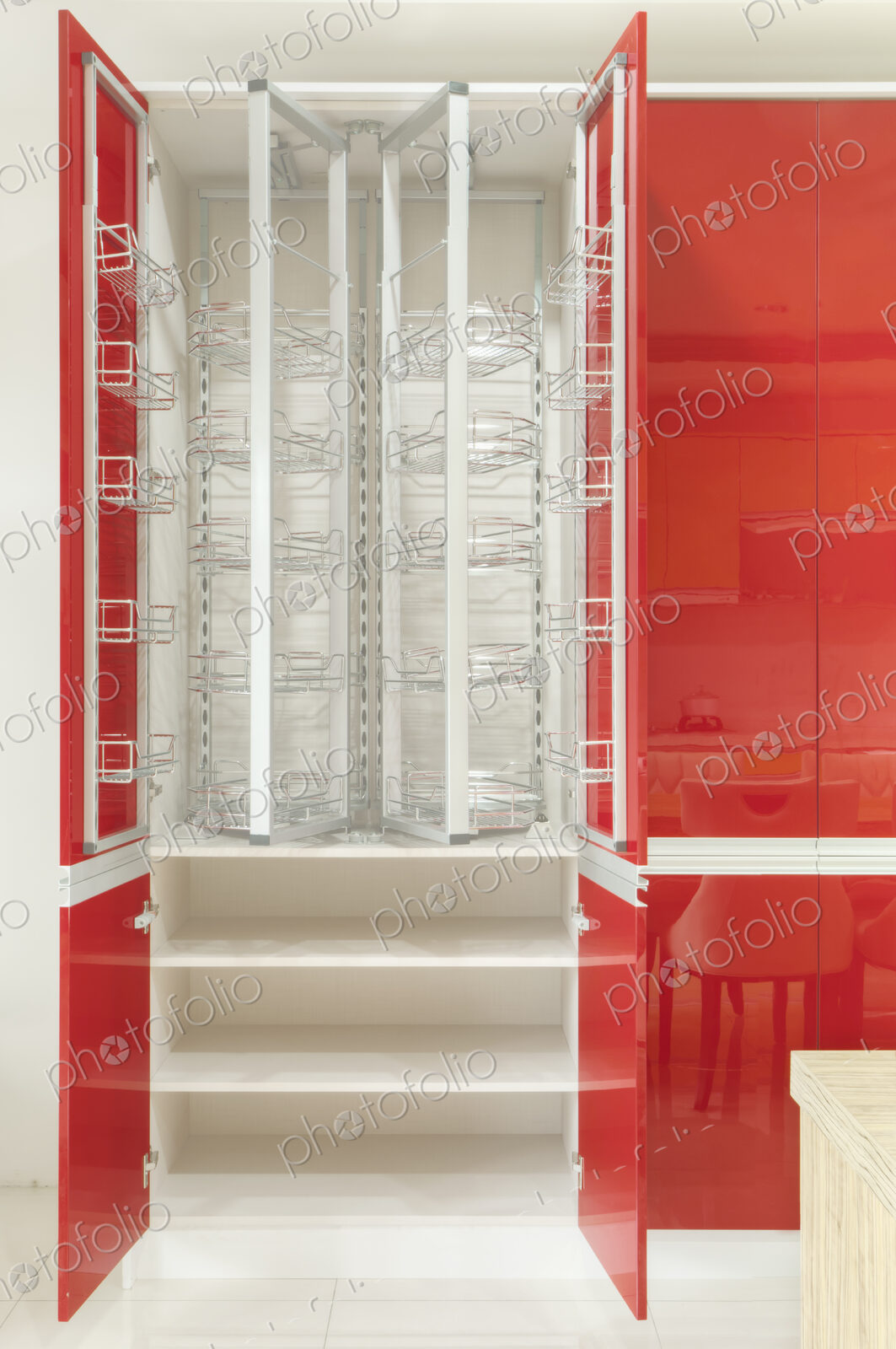 Kitchen cupboard with stainless steel metal racking, microwave oven and a stainless…