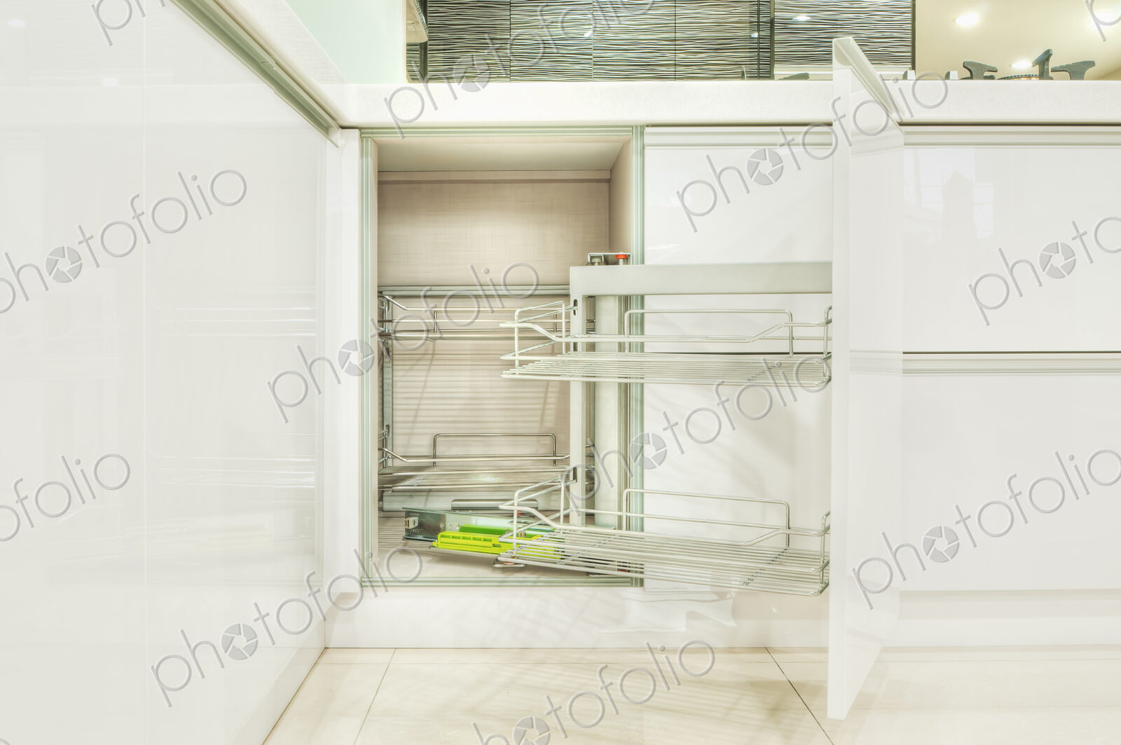 Kitchen cupboard with stainless steel metal racking, microwave oven and a stainless…