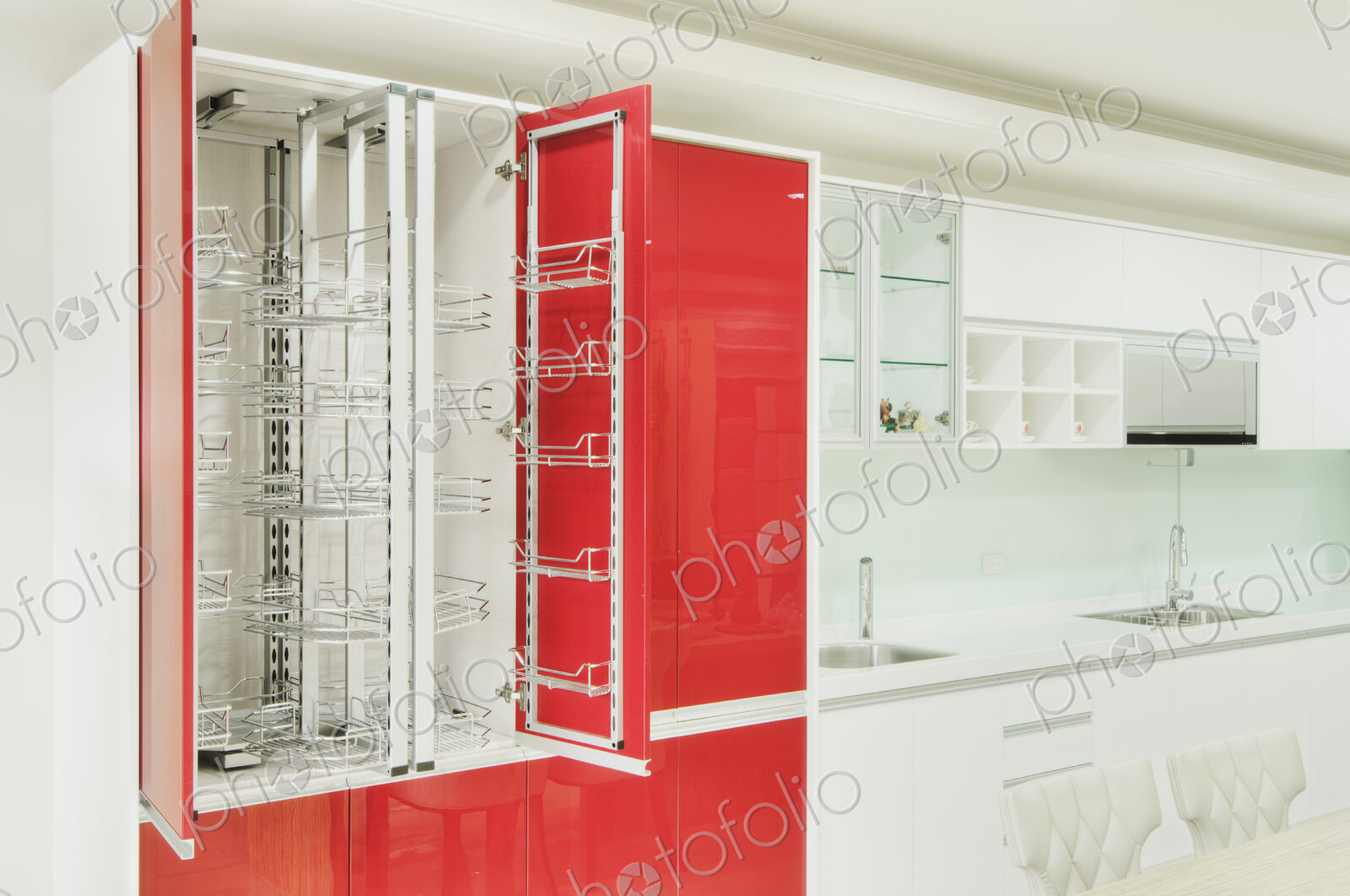 Kitchen cupboard with stainless steel metal racking, microwave oven and a stainless…