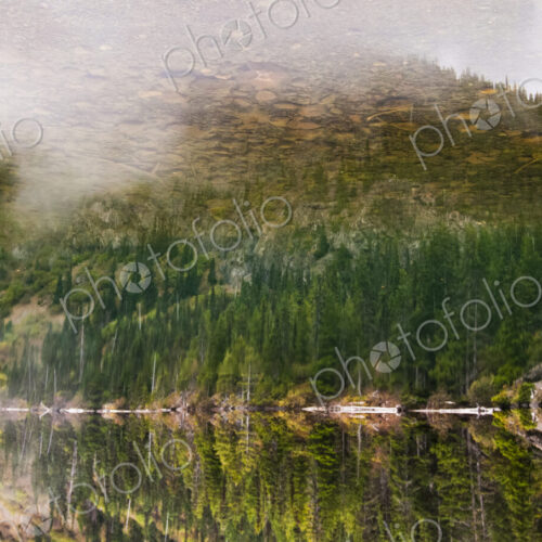 Lake Angeles, reflections in the water surface of the lake, tall trees and wooded… Lake Angeles, reflections in the water surface of the lake, tall trees and wooded…