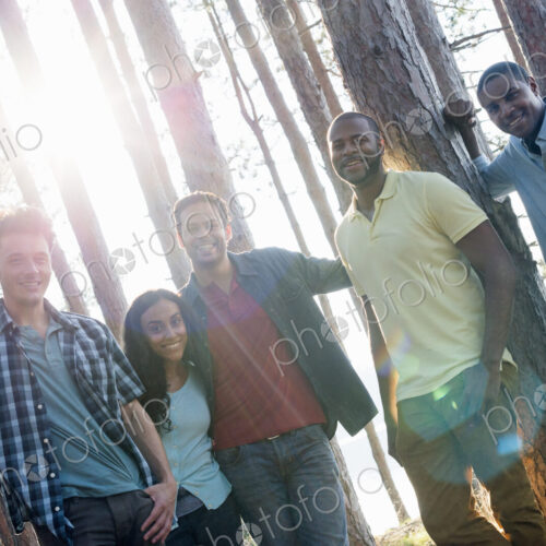 Lakeside. A group of people, friends gathered in the shade of pine trees in summer. Lakeside. A group of people, friends gathered in the shade of pine trees in summer.