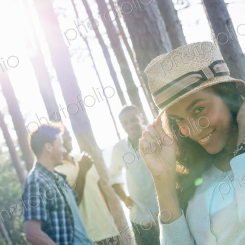 Lakeside. A group of people, friends gathered in the shade of pine trees in summer. Lakeside. A group of people, friends gathered in the shade of pine trees in summer.