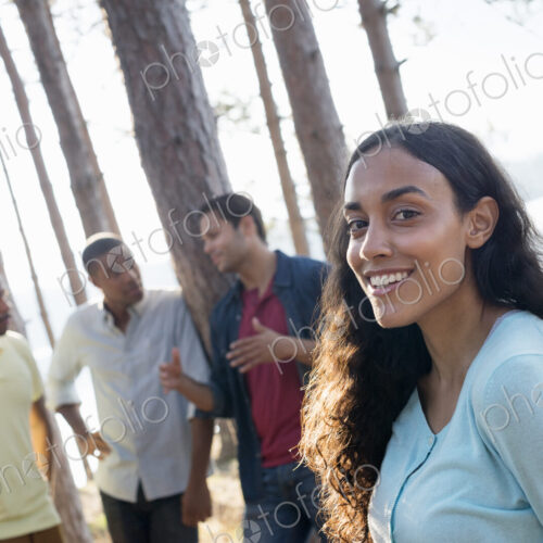Lakeside. A group of people, friends gathered in the shade of pine trees in summer. Lakeside. A group of people, friends gathered in the shade of pine trees in summer.