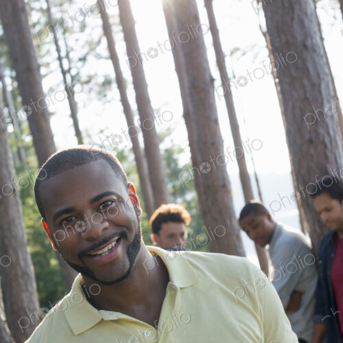 Lakeside. A group of people, friends gathered in the shade of pine trees in summer. Lakeside. A group of people, friends gathered in the shade of pine trees in summer.