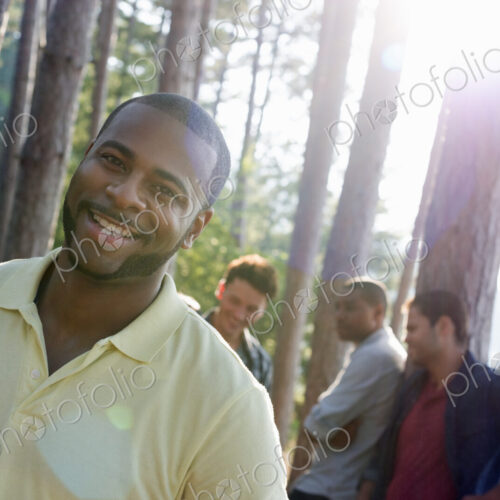 Lakeside. A group of people, friends gathered in the shade of pine trees in summer. Lakeside. A group of people, friends gathered in the shade of pine trees in summer.