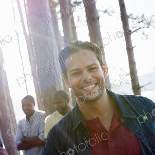Lakeside. A group of people, friends gathered in the shade of pine trees in summer. Lakeside. A group of people, friends gathered in the shade of pine trees in summer.