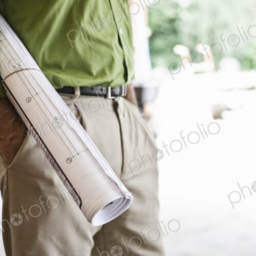 Landscape architect holding plans for a new yard design.