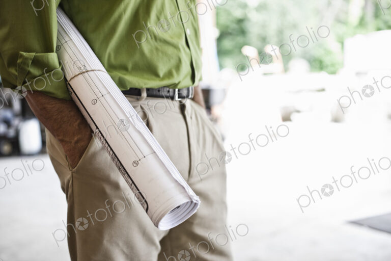 Landscape architect holding plans for a new yard design.