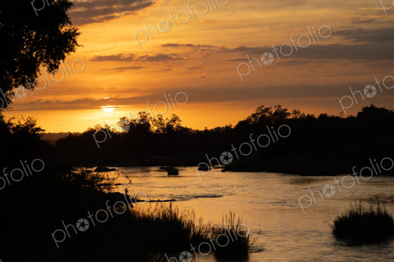 Landscape with sunset over a river.