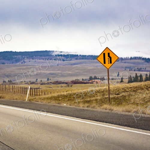 Lane merge sign on near Cle Elum, Interstate 90 and a view across the landscape. Lane merge sign on near Cle Elum, Interstate 90 and a view across the landscape.