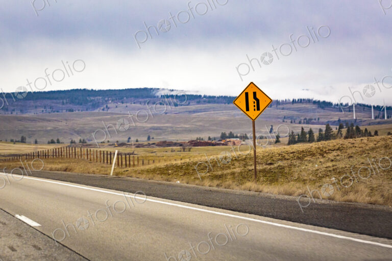 Lane merge sign on near Cle Elum, Interstate 90 and a view across the landscape.