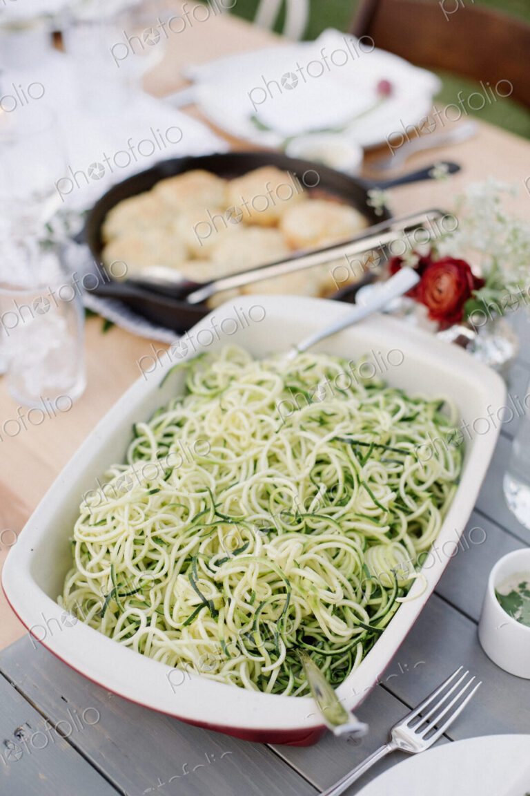 Large dish with a salad on a table in a garden.