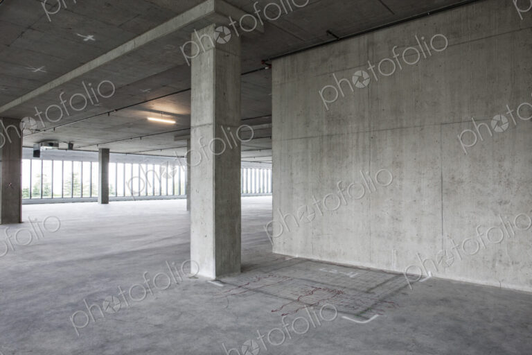Large empty raw office space with plans sketched onto the floor in chalk.