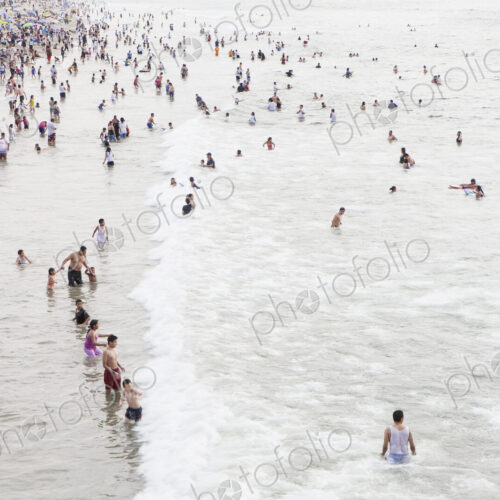 Large group of people swimming in the ocean at Santa Monica, California. Large group of people swimming in the ocean at Santa Monica, California.