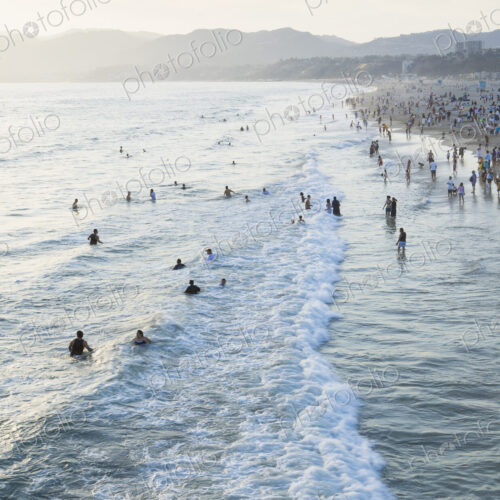 Large group of people swimming in the ocean at Santa Monica, California. Large group of people swimming in the ocean at Santa Monica, California.