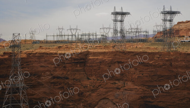 Large power lines on pylons crossing a canyon in Arizona, reaching into the distance.