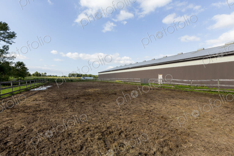 Large rural building and paddock in the country.