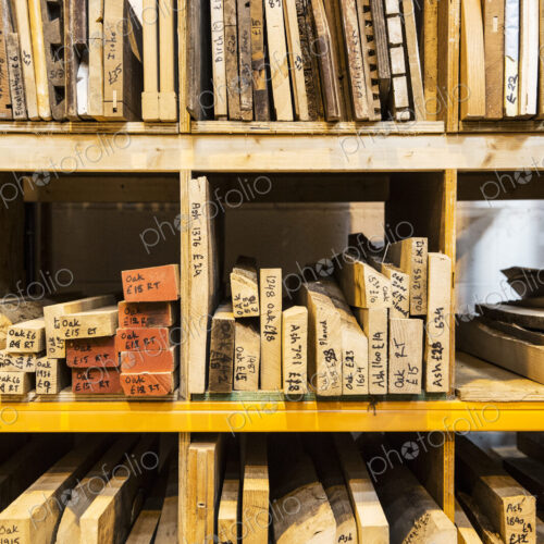 Large selection of wooden planks and boards stacked on shelves in a warehouse. Large selection of wooden planks and boards stacked on shelves in a warehouse.