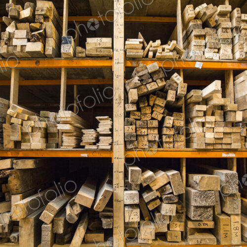 Large selection of wooden planks stacked on shelves in a warehouse. Large selection of wooden planks stacked on shelves in a warehouse.