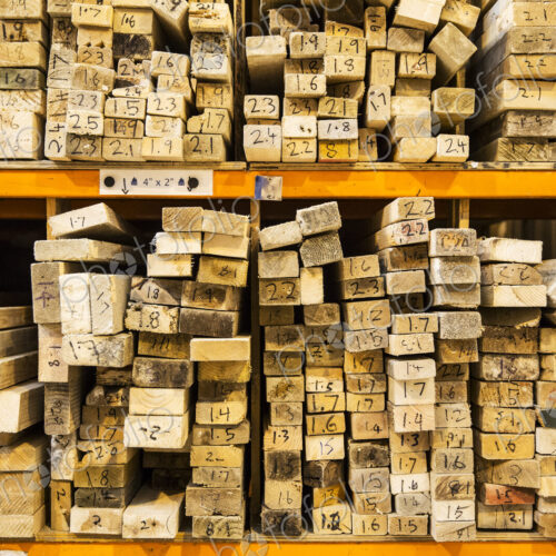 Large selection of wooden planks stacked on shelves in a warehouse. Large selection of wooden planks stacked on shelves in a warehouse.
