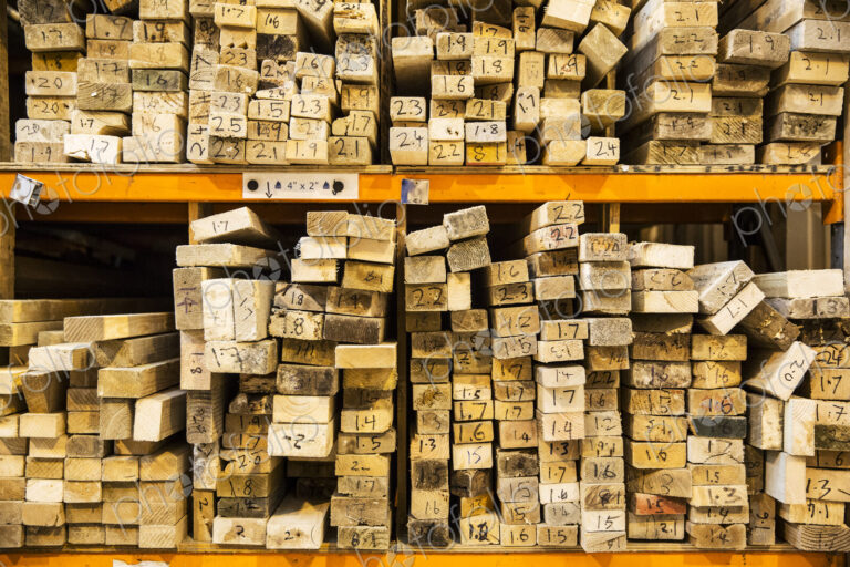 Large selection of wooden planks stacked on shelves in a warehouse.