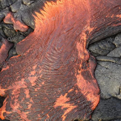Lava flow over volcanic black rock.