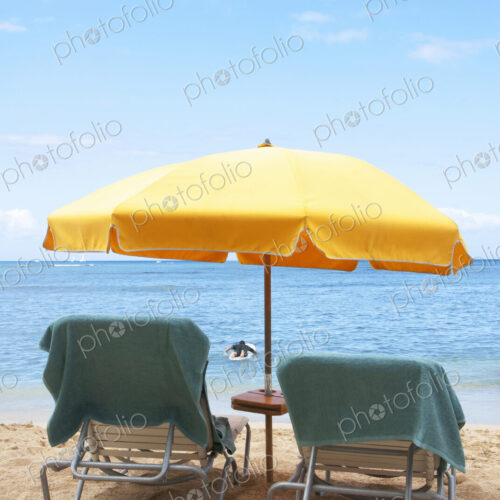 Lawn chairs and umbrella on beach Lawn chairs and umbrella on beach