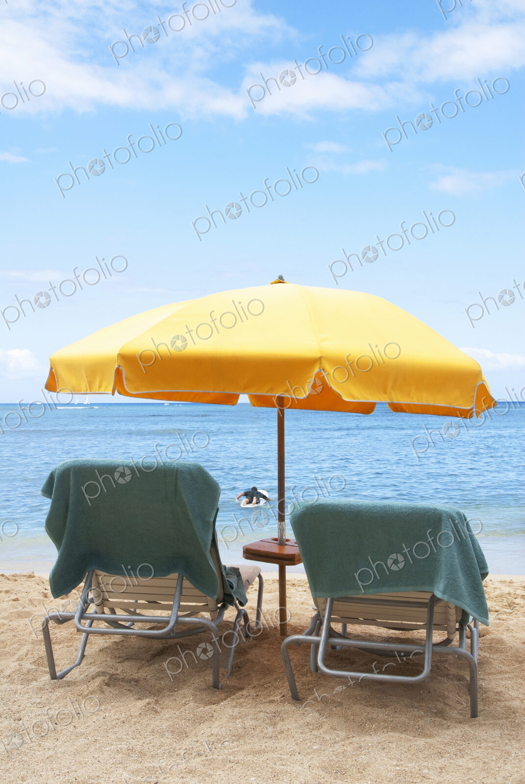 Lawn chairs and umbrella on beach