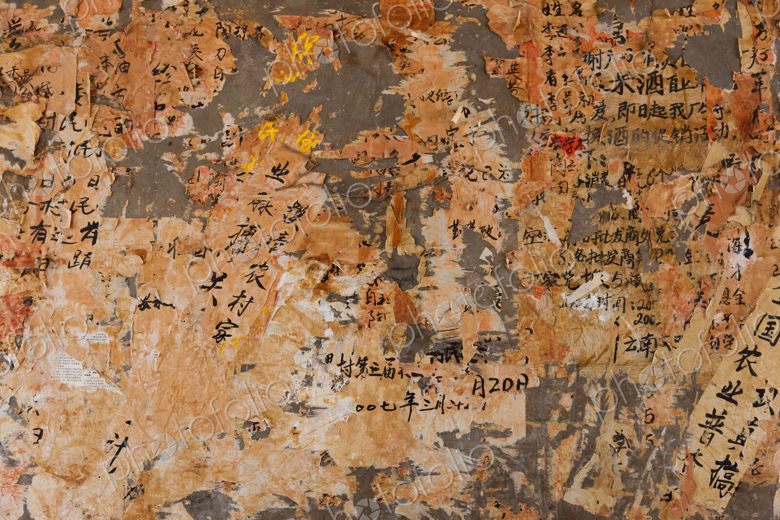 Layers of paper peeling off a wall, Kunming, China