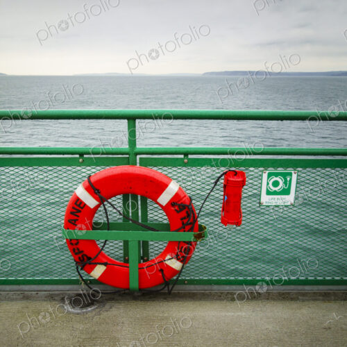 Life ring on railing of a Puget Sound ferry crossing from Edmonds to Kingston, WA USA Life ring on railing of a Puget Sound ferry crossing from Edmonds to Kingston, WA USA