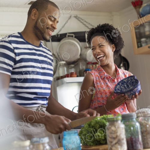 Lifestyle. Two people working in a farmhouse kitchen.