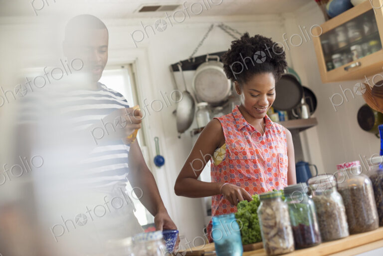 Lifestyle. Two people working in a farmhouse kitchen.