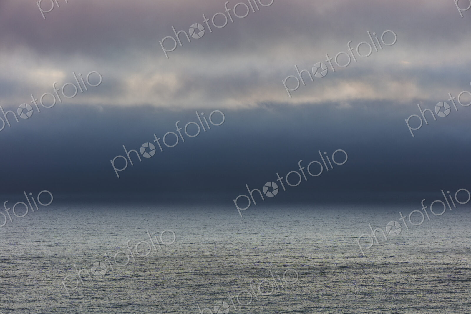 Lifting clouds and fog over vast ocean
