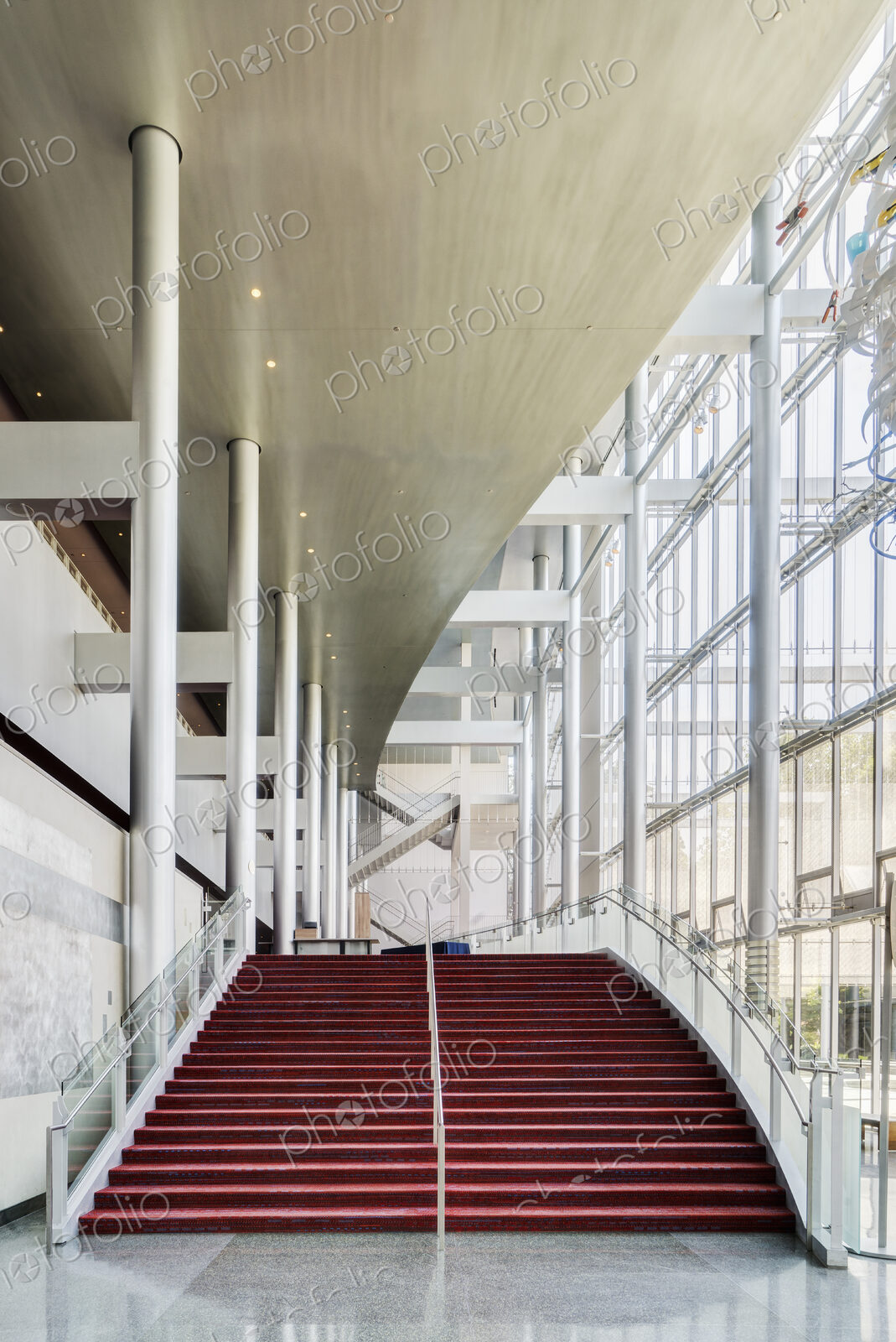 Light and airy atrium of a modern building with marble floors.