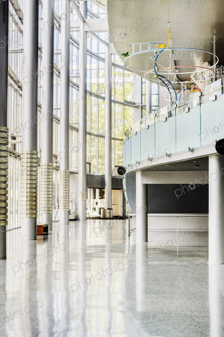 Light and airy atrium of a modern building with marble floors.