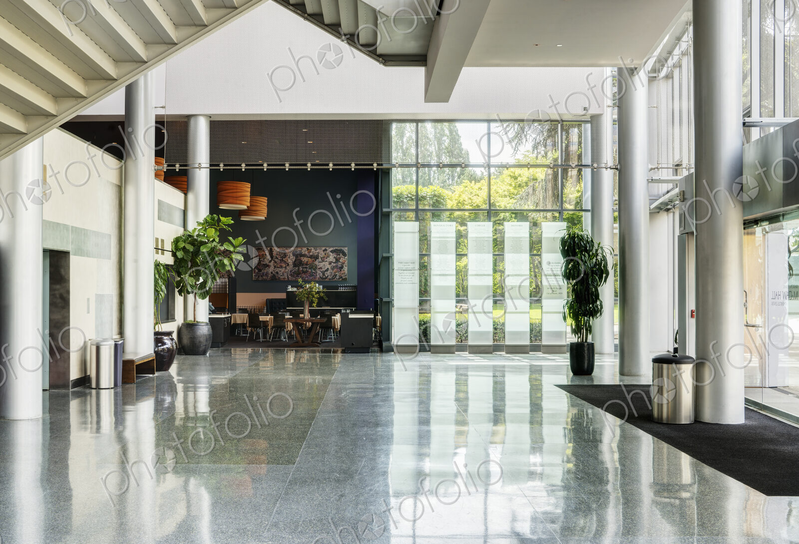 Light and airy atrium of a modern building with marble floors.