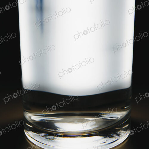 Light shining through glass of filtered water.