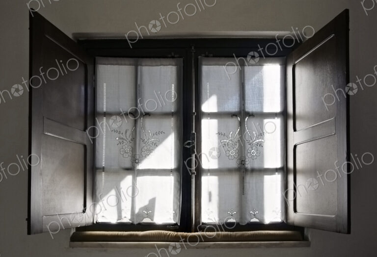 Light streaming through lace curtains