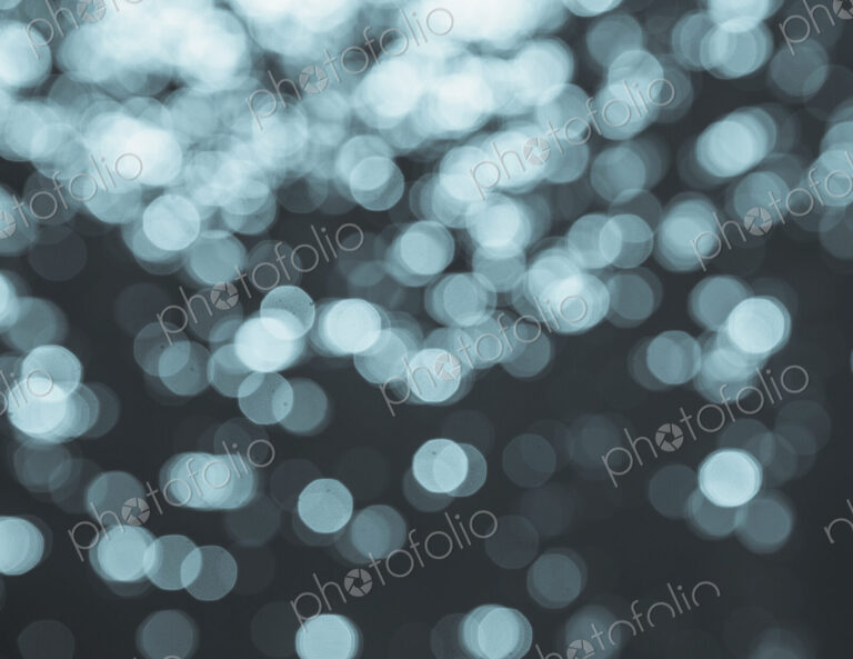 Lights reflecting off the water surface, on the Pacific ocean at Big Sur, California.