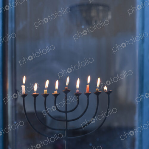 Lit Menorah on Windowsill