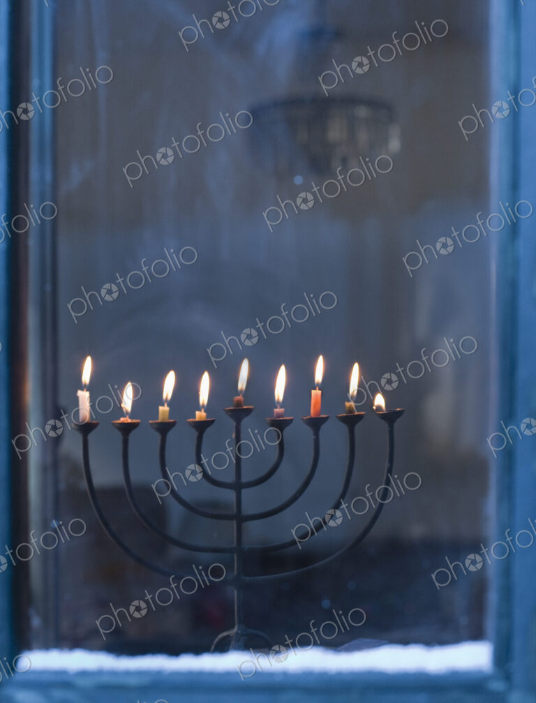 Lit Menorah on Windowsill