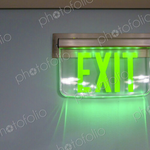 Lit exit sign on a wall Lit exit sign on a wall