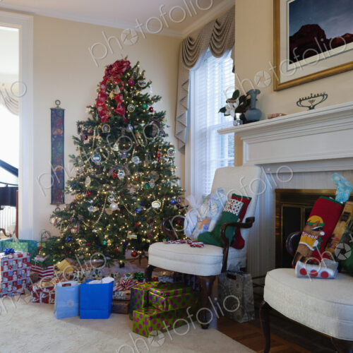 Living room with Christmas tree and gifts, traditional decorations, fireplace and… Living room with Christmas tree and gifts, traditional decorations, fireplace and…